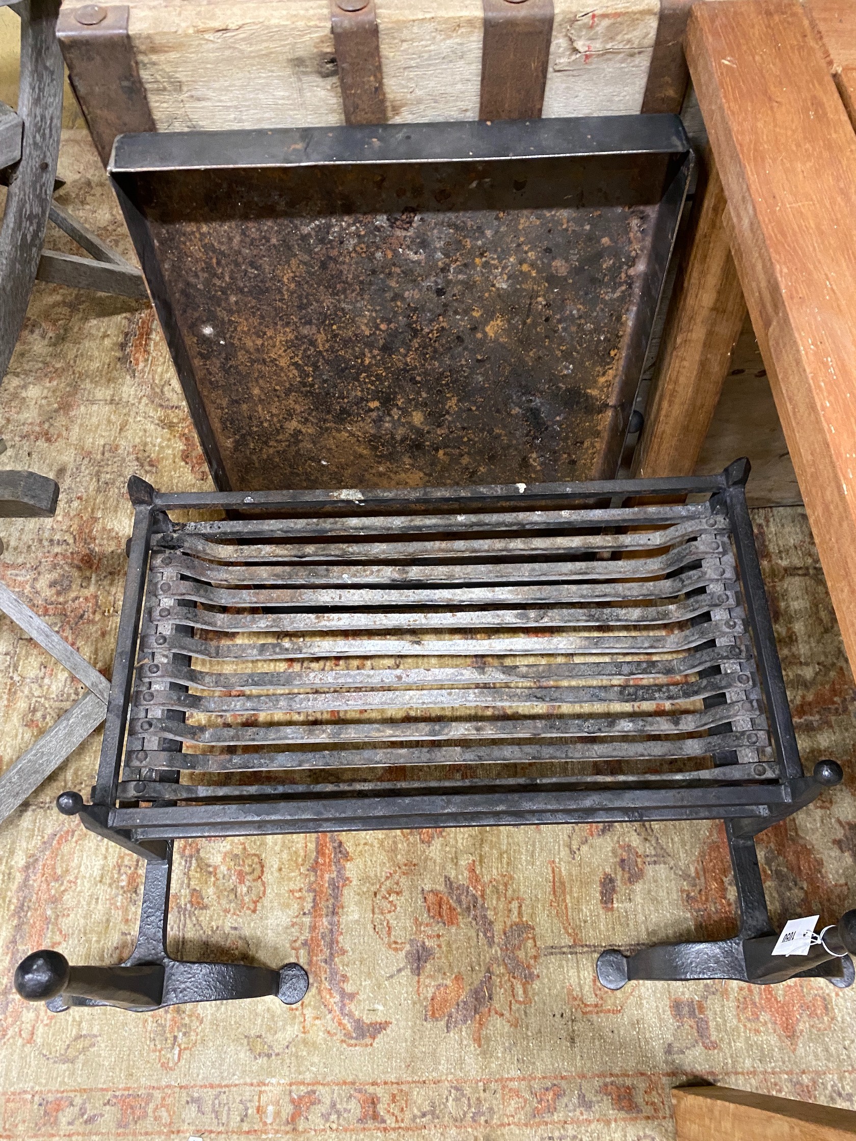 A wrought iron fire basket with dogs and ash pan, basket width 65cm, depth 35cm